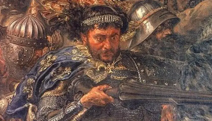Portret rycerza w zbroi i ozdobnym płaszczu, z hełmami w tle.